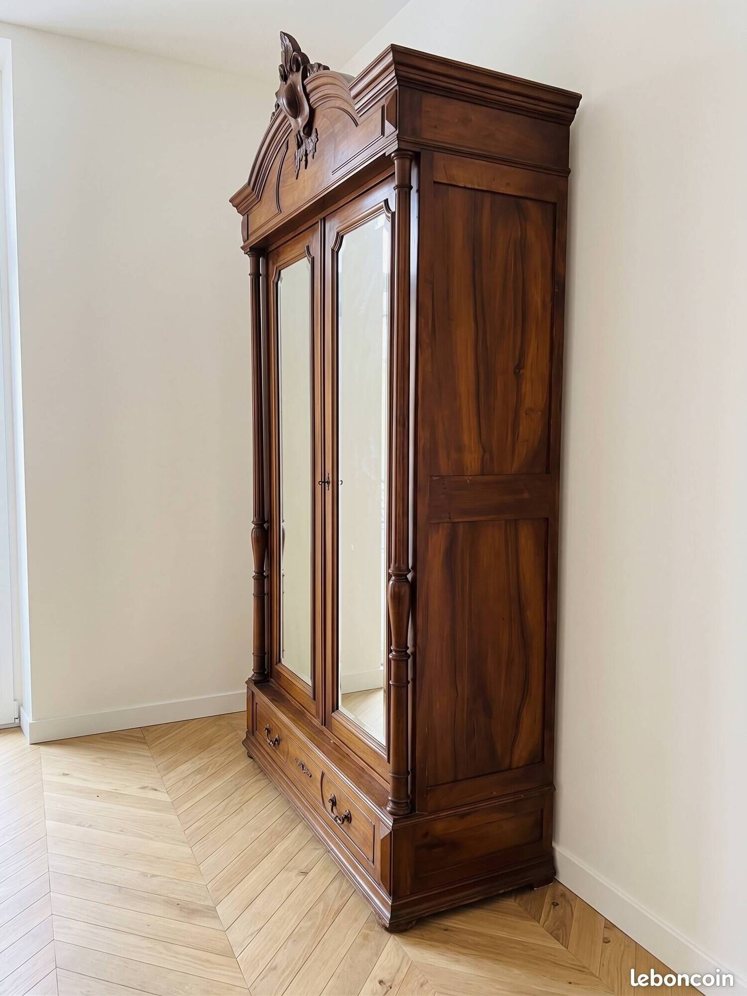 Antique walnut wardrobe with bevelled mirrors.