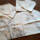 Round off-white tablecloth embroidered with grey flowers with 8 matching napkins - festive table