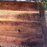 Antique farmhouse table in solid cherry wood with turned legs.