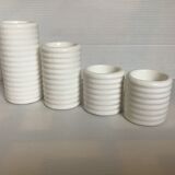 Four white earthenware candle holders