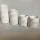 Four white earthenware candle holders