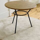 Tripod coffee table with a straw covering.