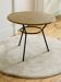 Tripod coffee table with a straw covering.