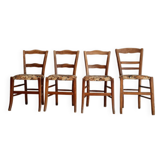 Antique wooden bistro chairs with flowered seats