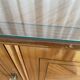 Vintage 4-door buffet with wood veneer and glass top.