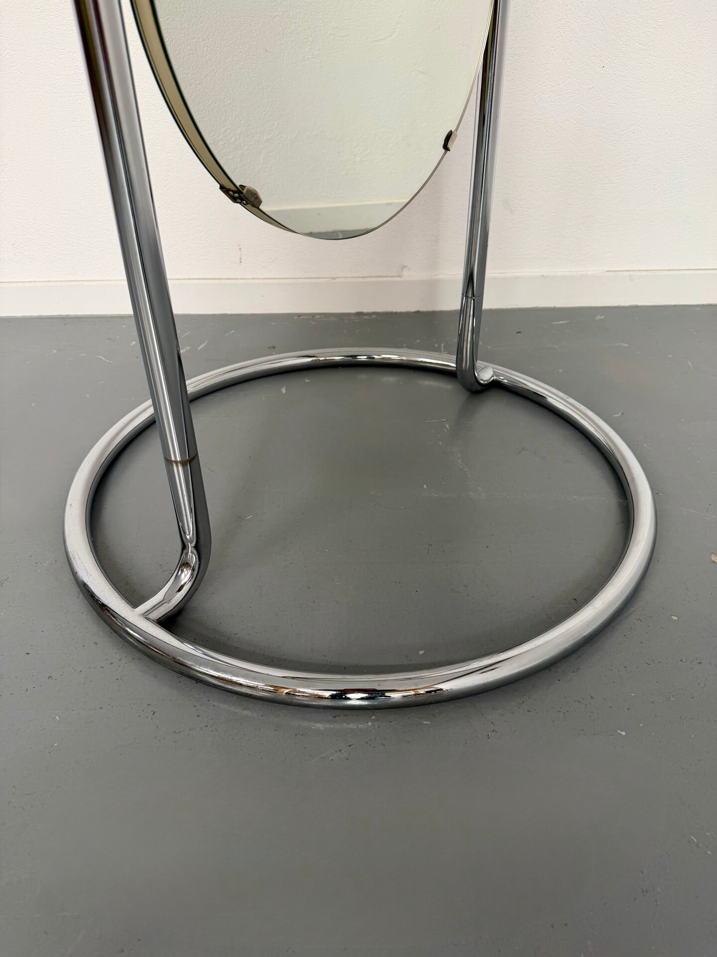 Large freestanding chrome metal full-length mirror in 1970s design.