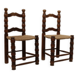 Pair of rustic chairs in turned wood with straw seats