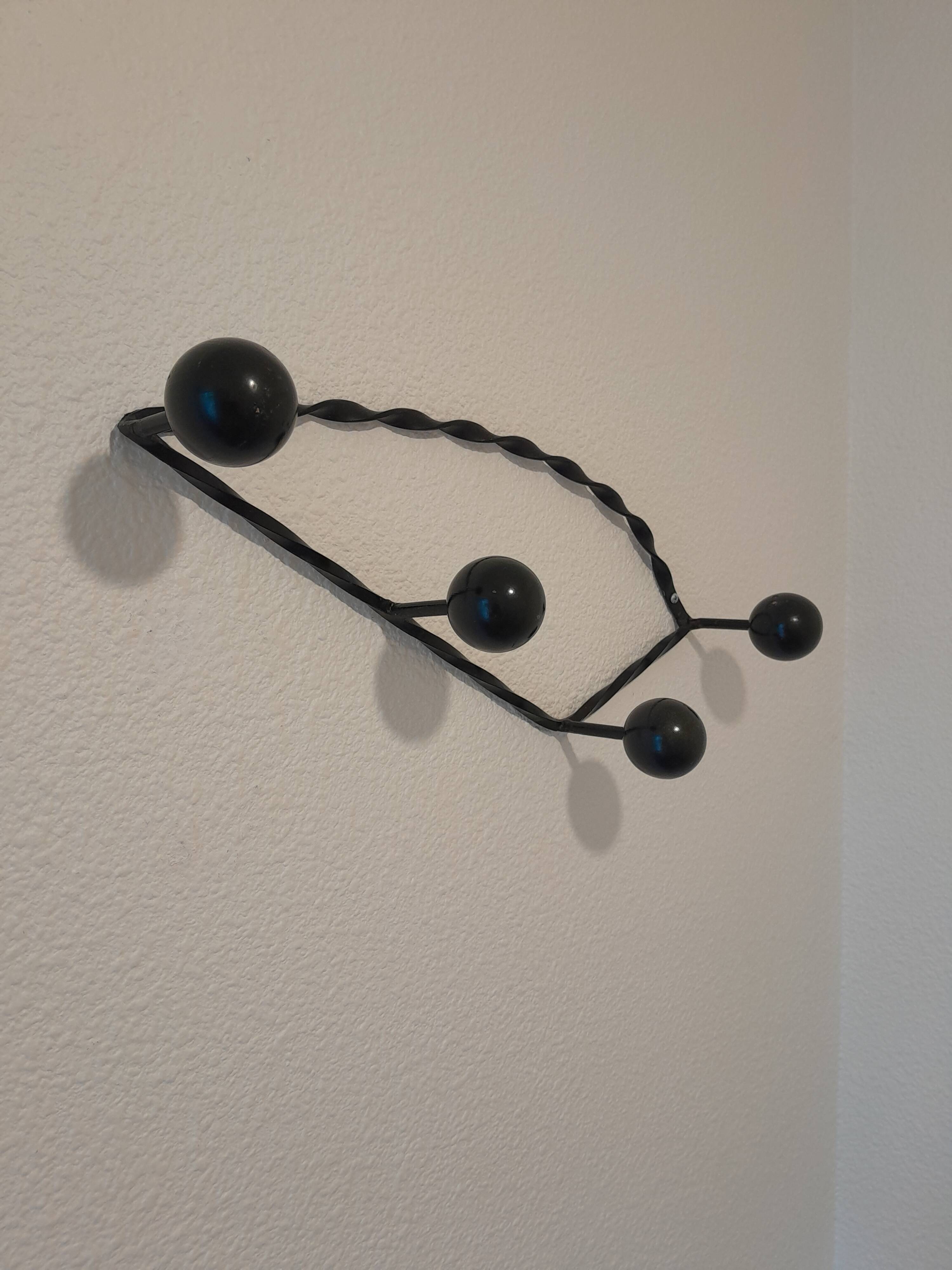 Antique design wall hook in wrought iron and painted wood.