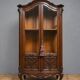 Curved library with two walnut doors, in Louis XV style.