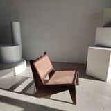 Reclined armchair in canned teak in natural wood
