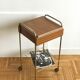 Serving bedside in gold metal and formica