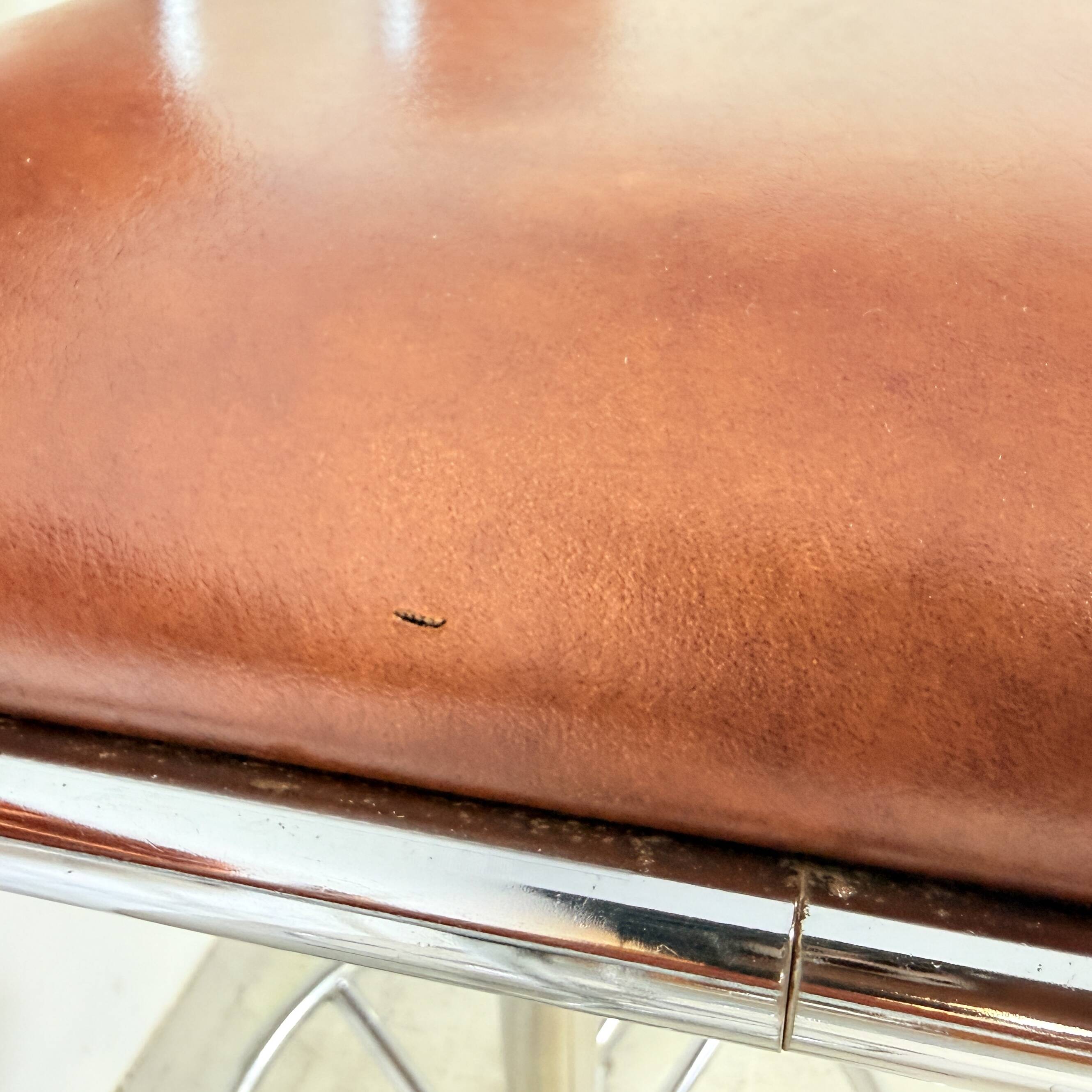 1970s chrome bar stools with cognac-colored faux leather upholstery