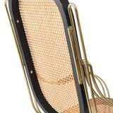 Modernist rocking chair in gilded brass and cane.
