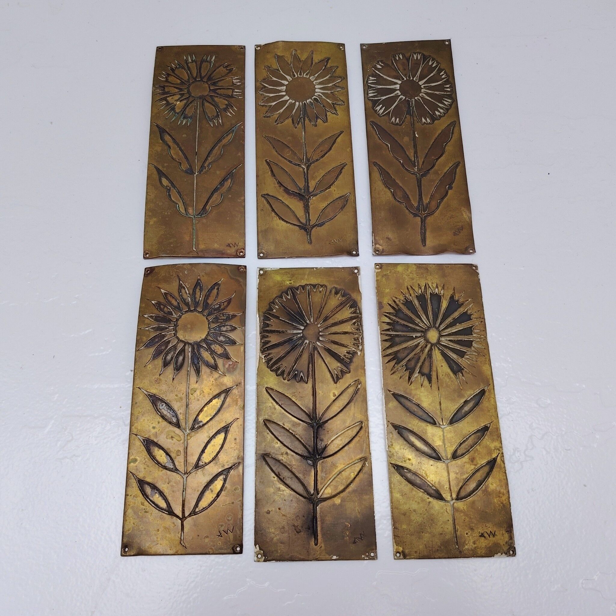 Six cleanliness plaques, flower design, brass.