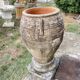 Large Cretan jar in terracotta with three handles on a stone base.