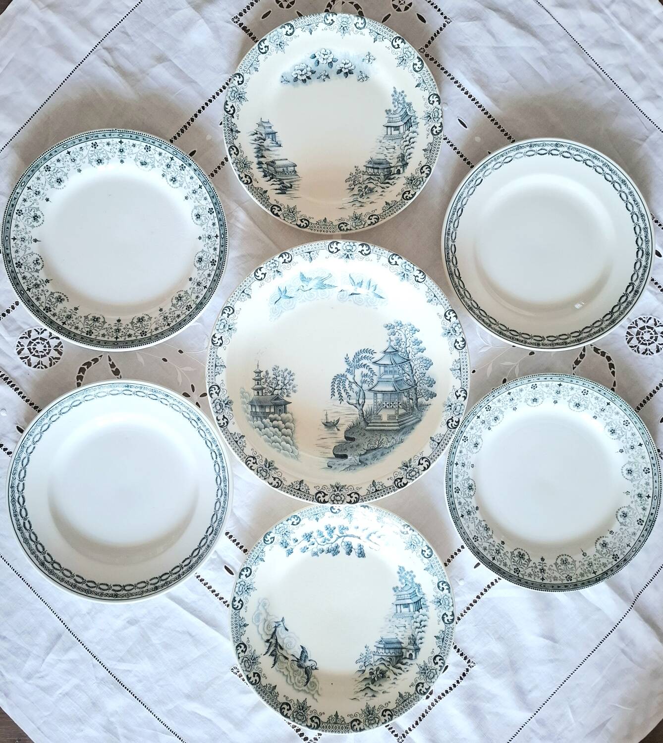 Mismatched antique flat plates made of ironstone accompanied by