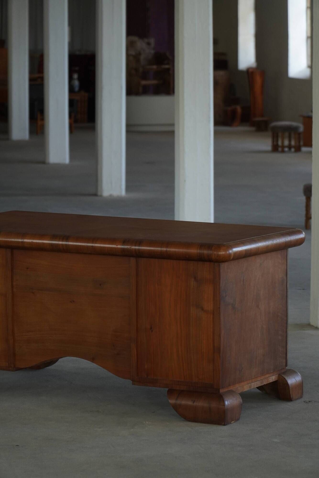 Art Deco desk, sculptural and expressive, in walnut, made by a French cabinetmaker, 1930s.