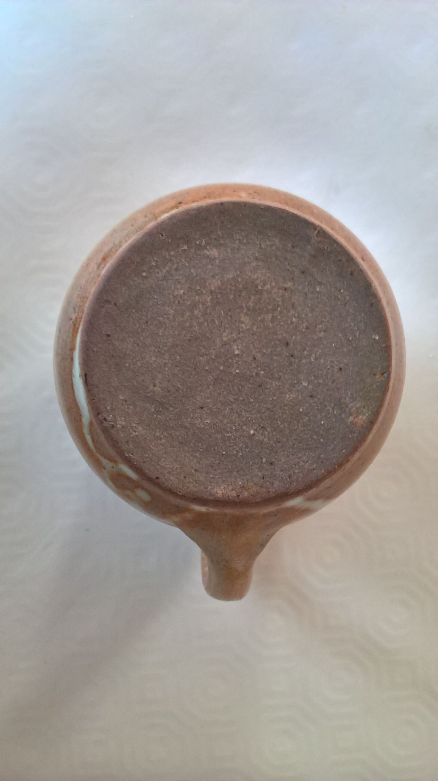 Creamy milk pot in sandstone