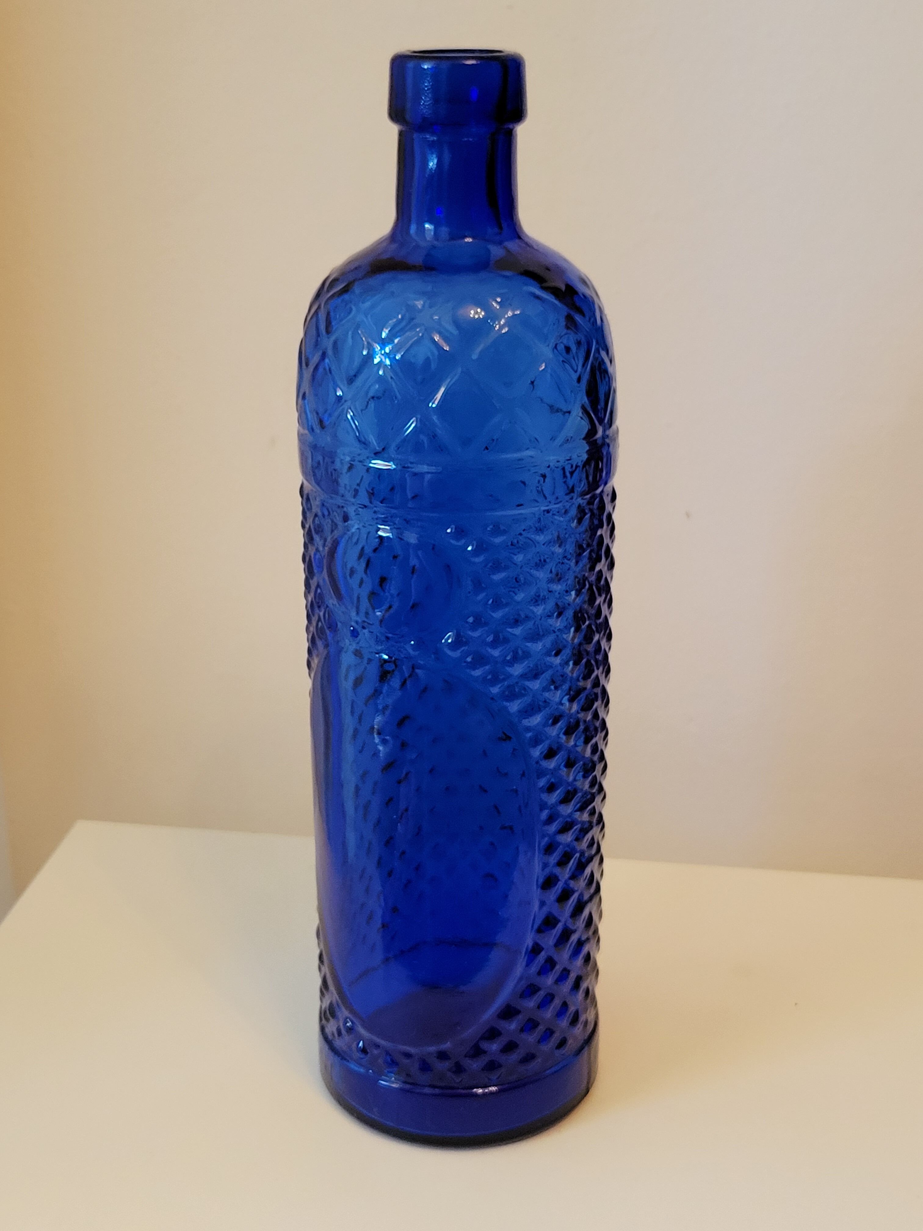 Vintage decanter bottle made of blue molded pressed glass