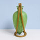 Rare glass paste amphora suspended in a wicker frame.