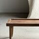 Brown Indonesian teak coffee table, with a border and cylindrical legs H40 L103.