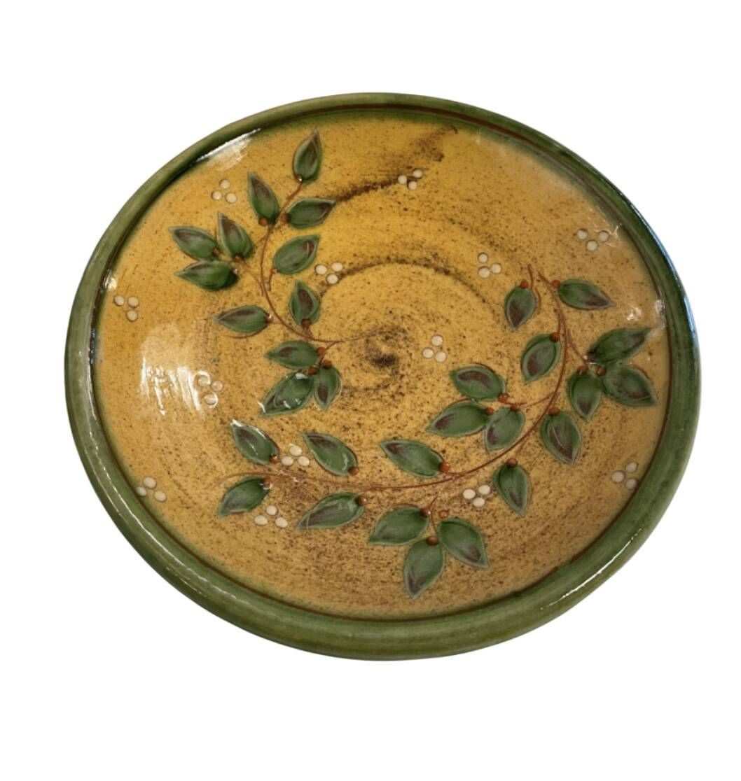 Decorative glazed terracotta plate with olive leaf pattern.