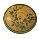 Decorative glazed terracotta plate with olive leaf pattern.