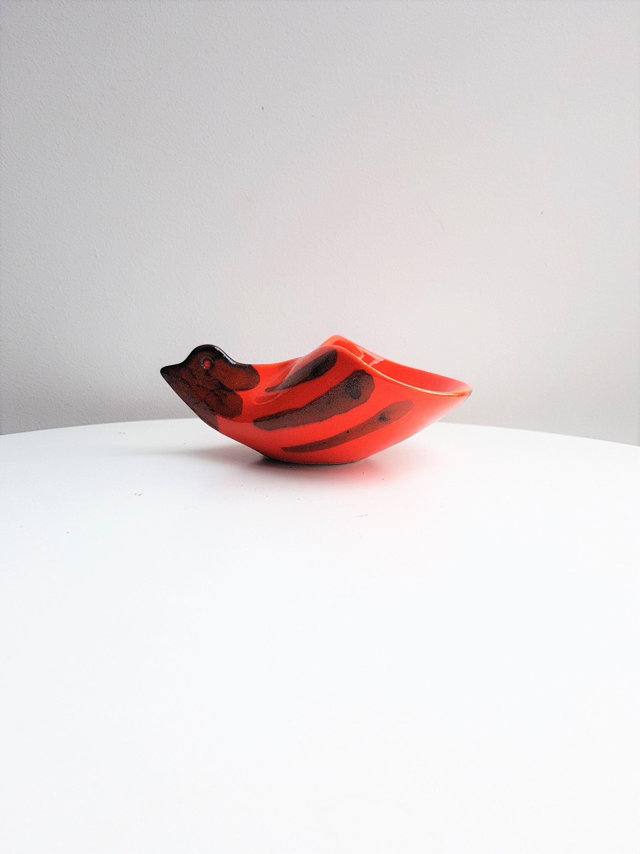 Empty orange enamelled pocket bird years 70