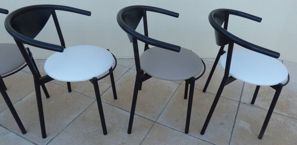 6 gondola-style chairs with a sturdy metal frame and faux leather.