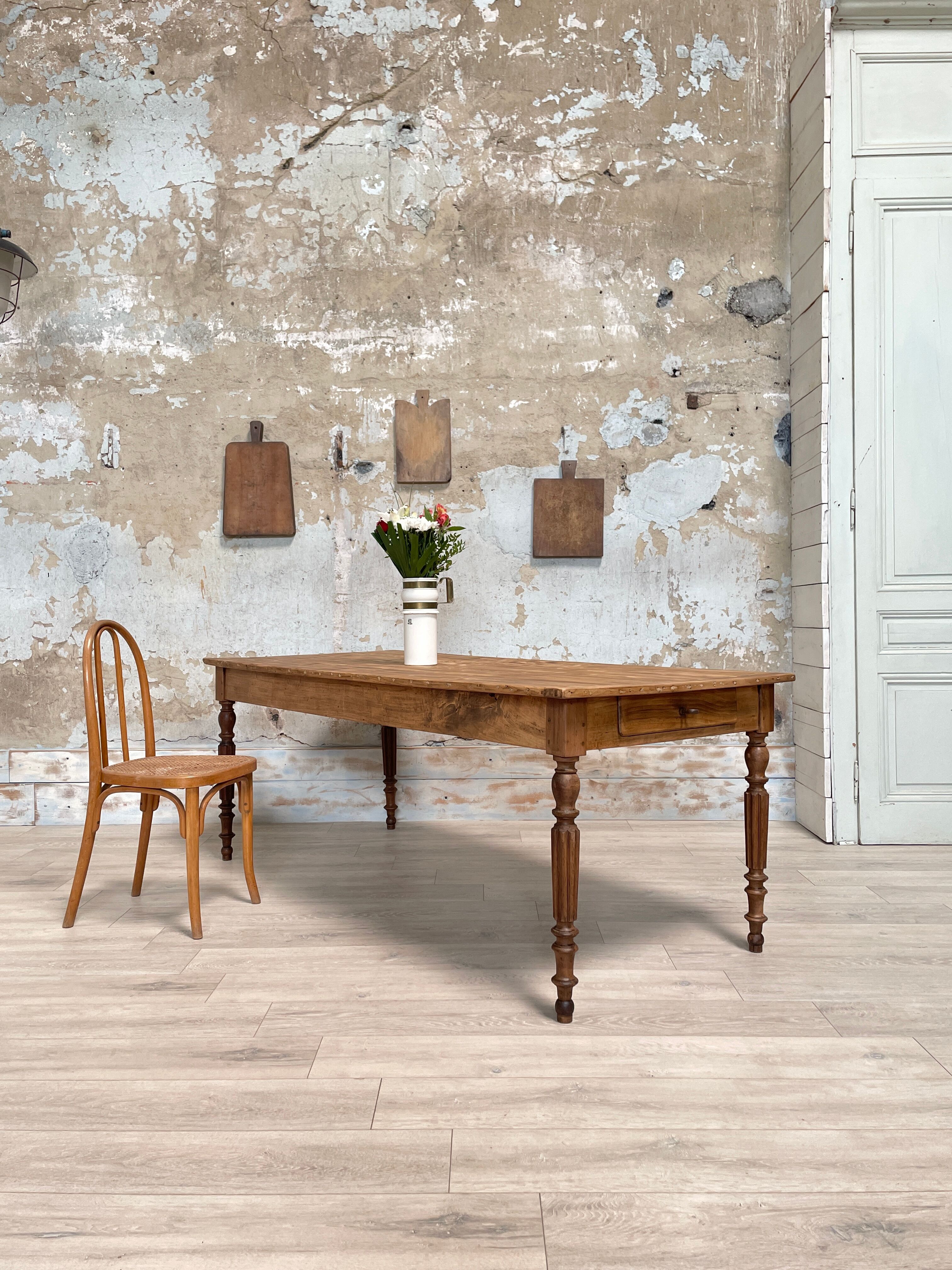 Vintage farmhouse table with turned legs.