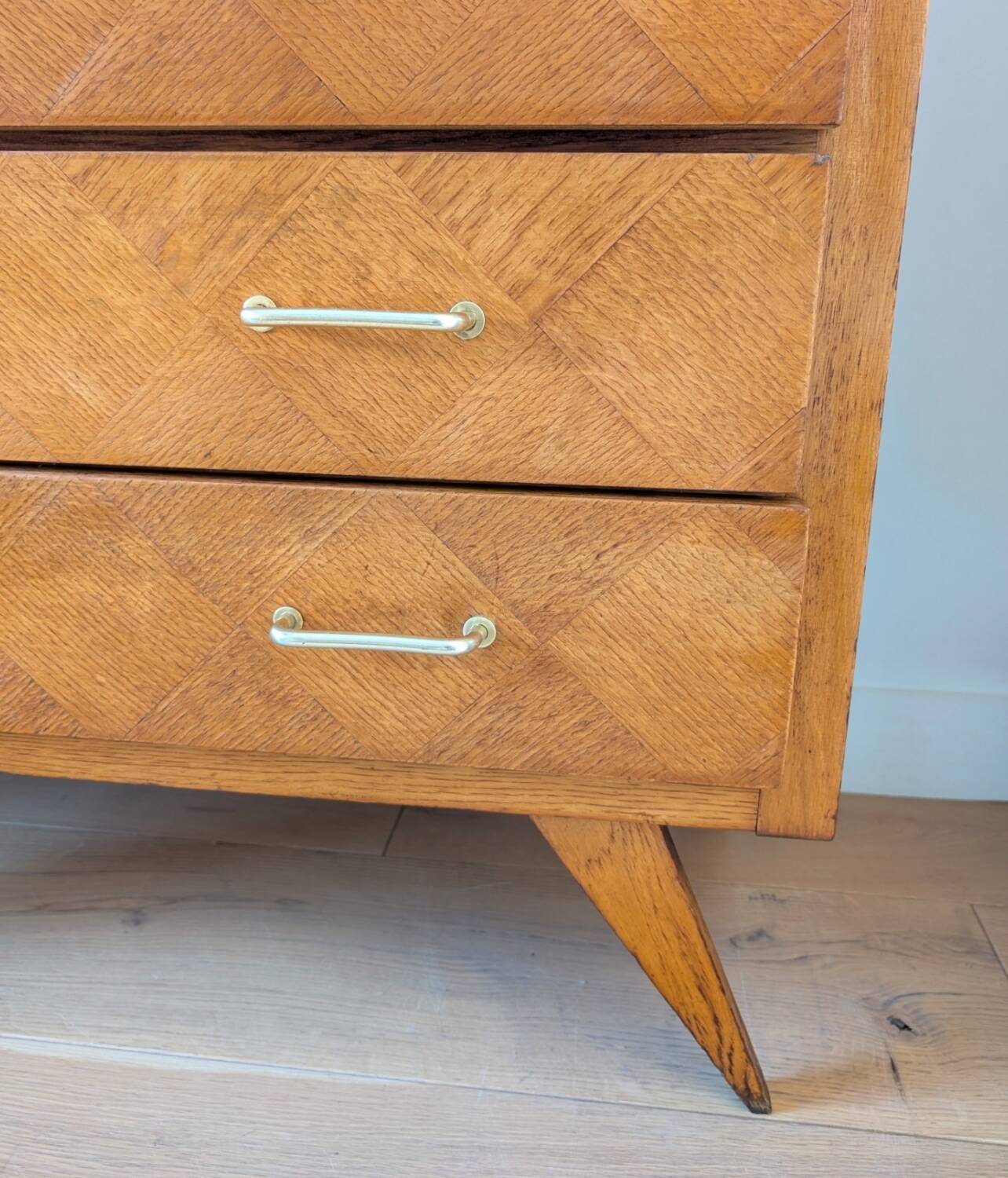 Vintage chest of drawers with checkerboard and compass feet