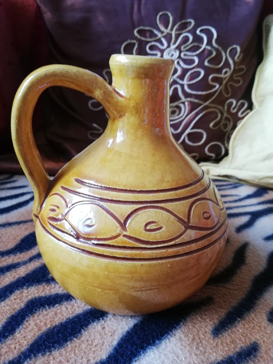 Round ochre glazed jug with handle