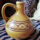 Round ochre glazed jug with handle