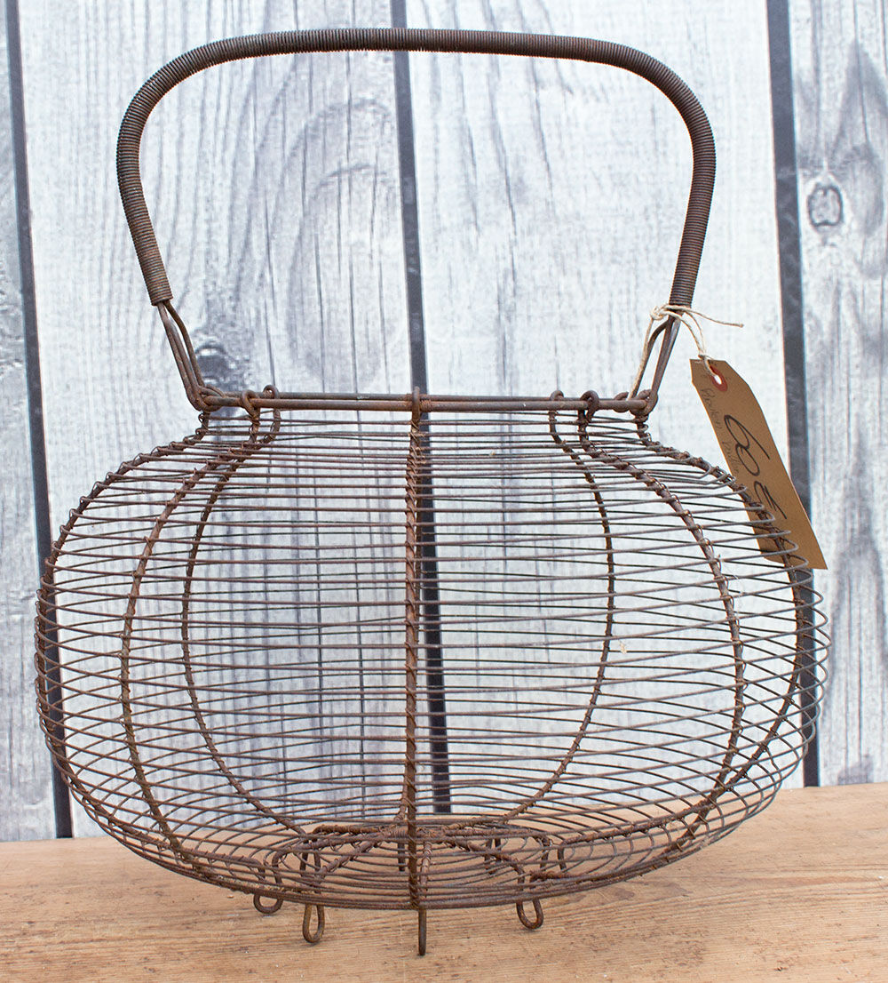 Old basket has wire eggs