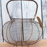 Old basket has wire eggs