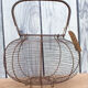 Old basket has wire eggs