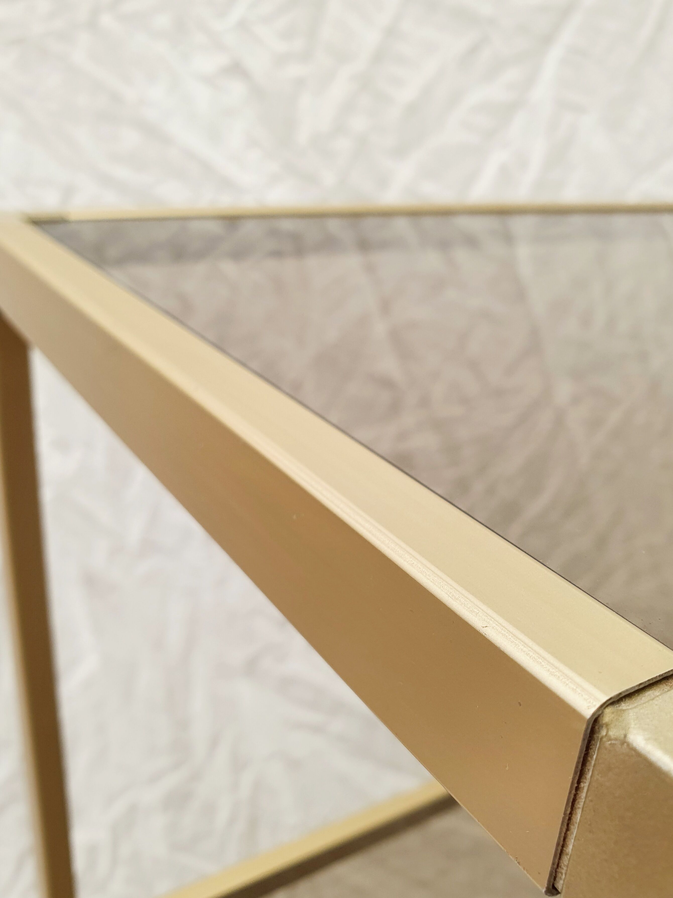 Golden metal shelf and smoked glass