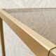 Golden metal shelf and smoked glass