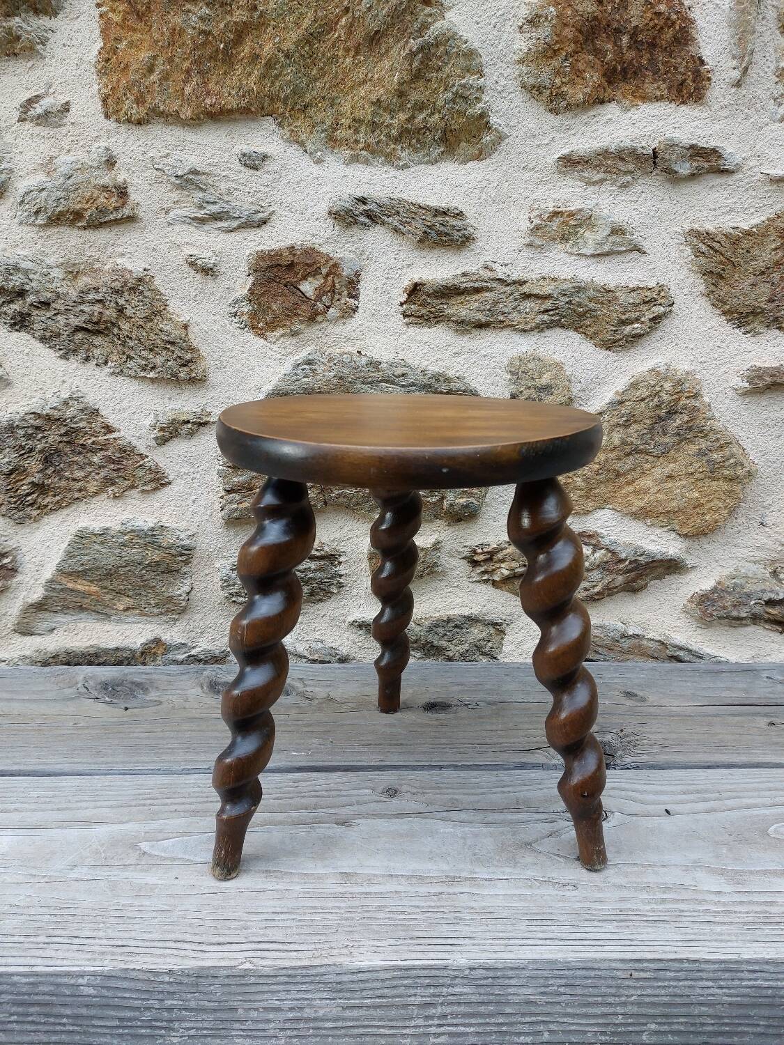 Wooden tripod stool with twisted legs
