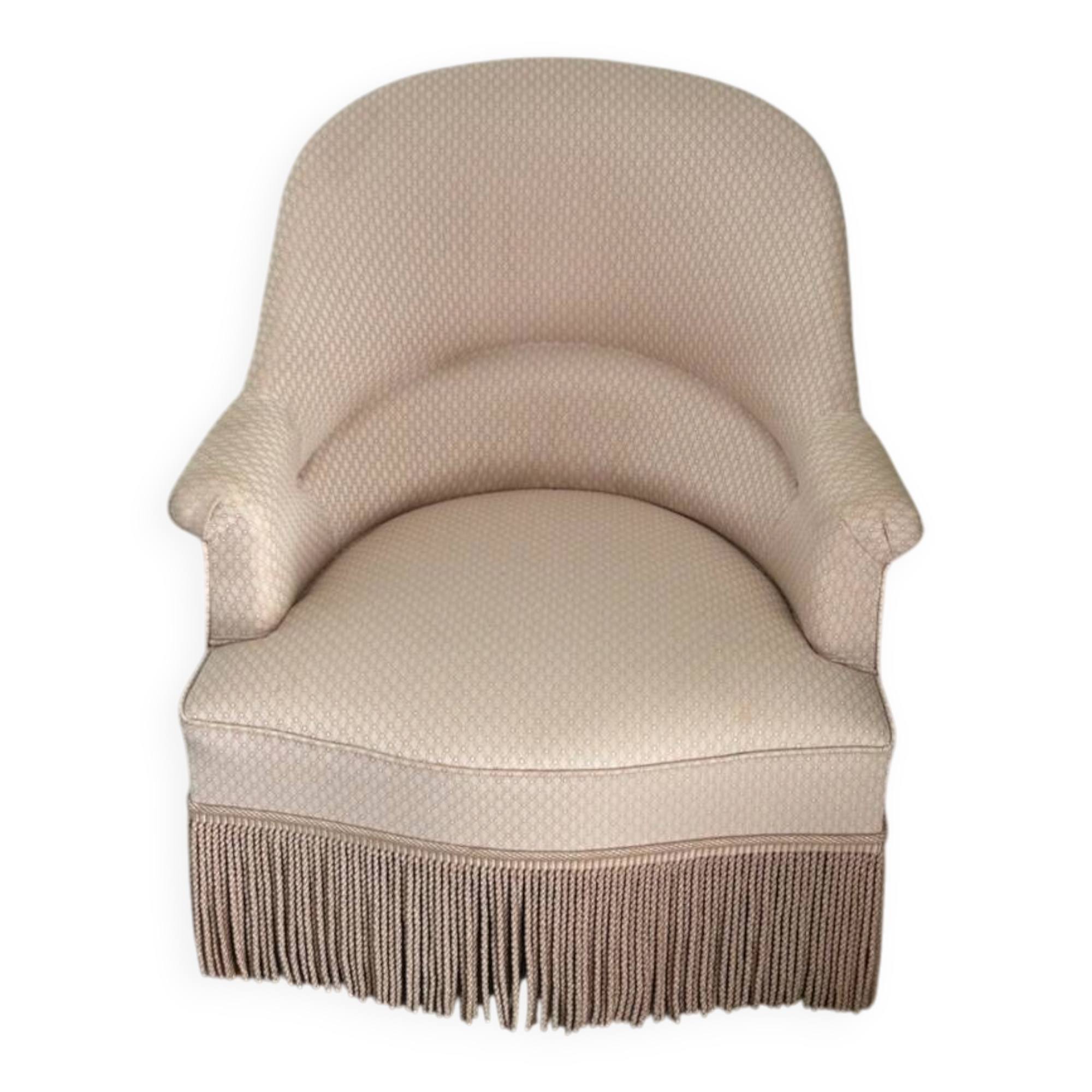Pink armchair with patterns and fringes.