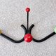 Vintage metal and wood coat rack in yellow/red/green.