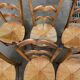 6 solid wood chairs with straw seats and butterfly carved backs.