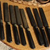 A set of 8 knives with black wooden handles