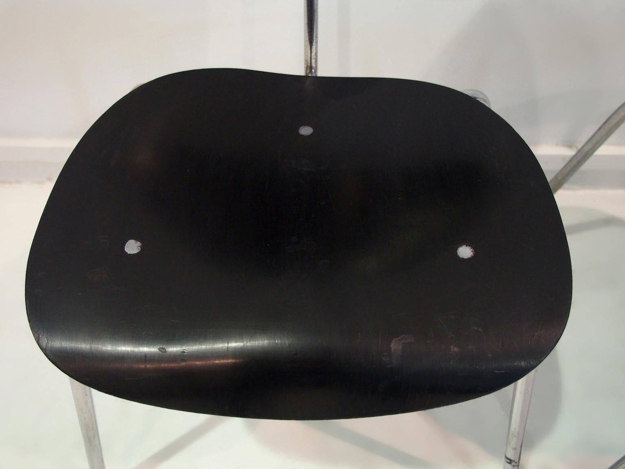 Set of four Egon Eiermann model SE 68 chairs in black lacquered plywood and steel.