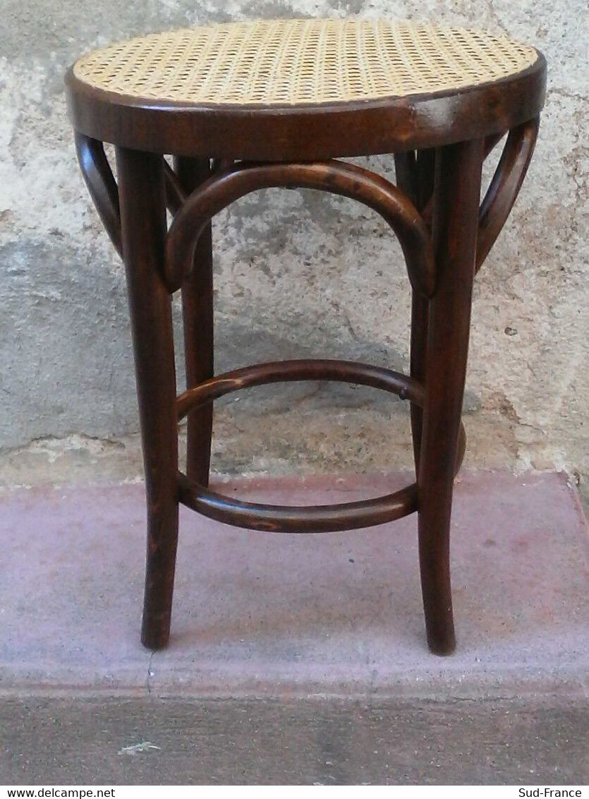 Low stool with canned seat and curved wood