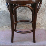 Low stool with canned seat and curved wood