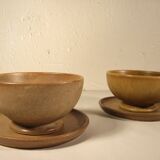 Two sandstone bowls and saucers