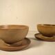 Two sandstone bowls and saucers