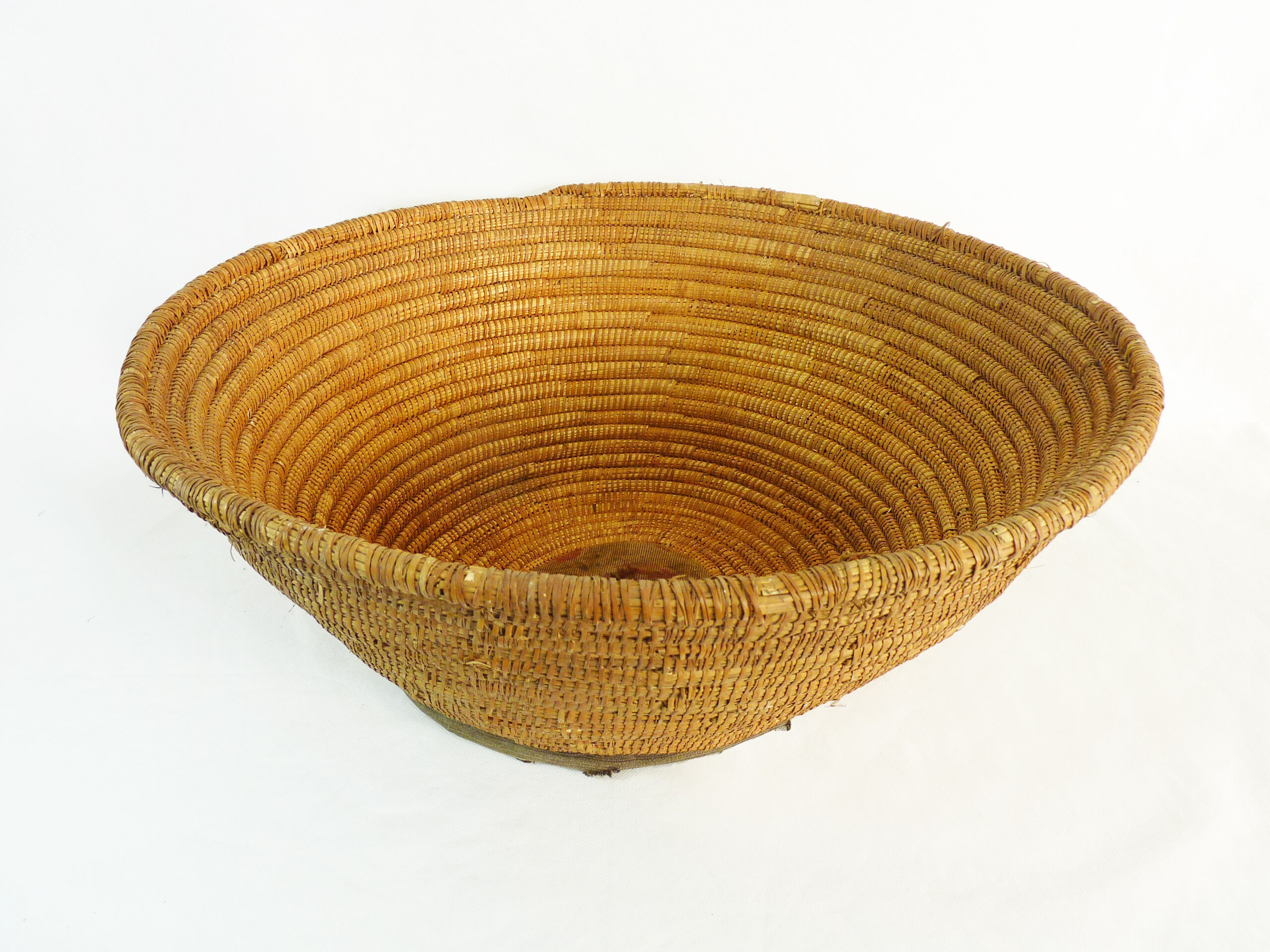 Old large bread basket of baker in braided wicker
