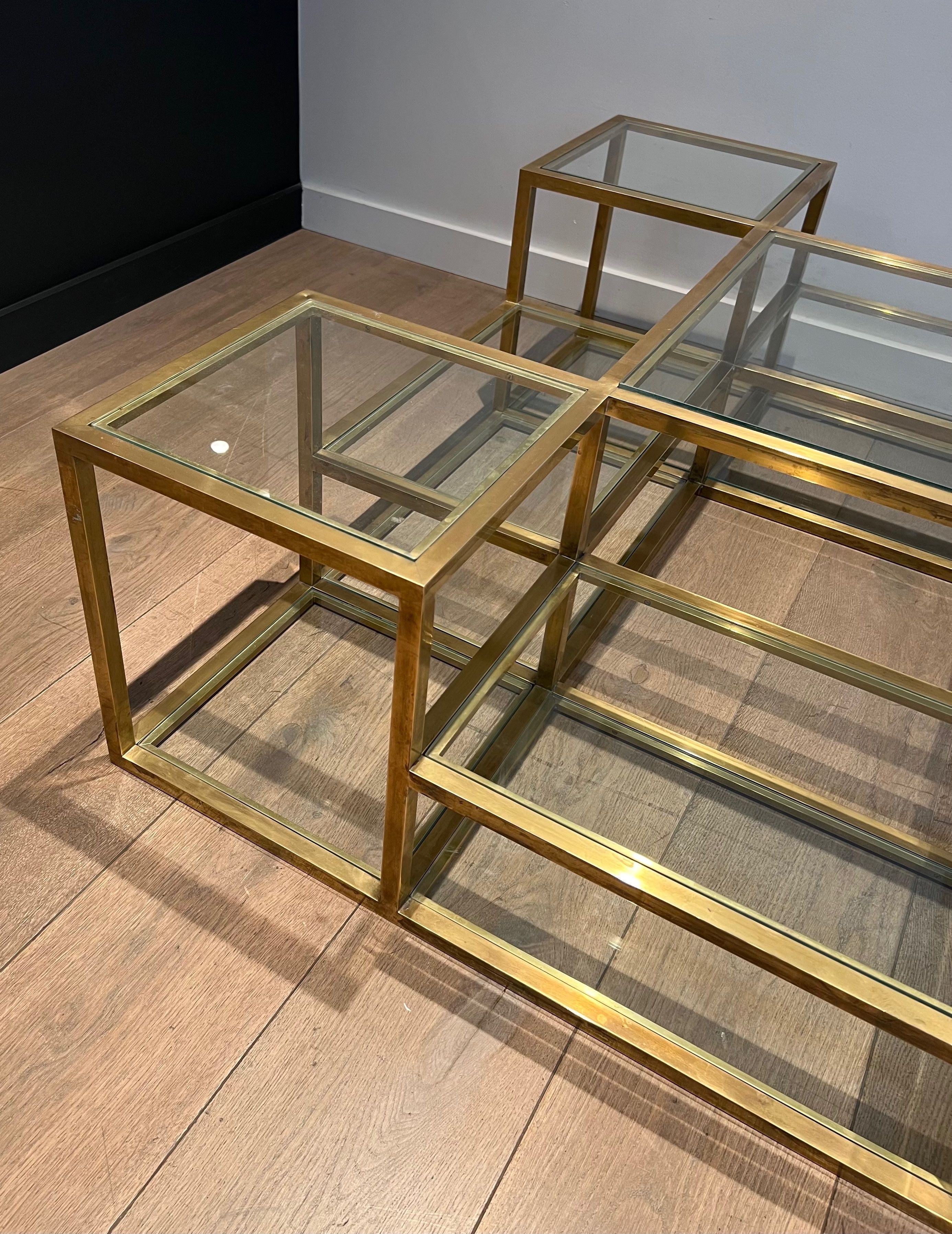 Important brass coffee table with multiple levels.